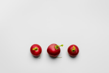 Top view of organic radishes on white background flat lay.