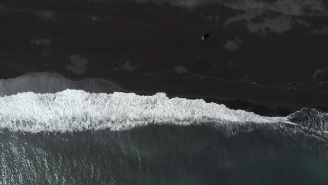 Aerial Top down view drone Iceland Reynisfjara Black Sand Beach with Basalt Columns