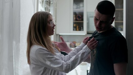 Young Couple Arguing and Fighting. Domestic Violence and Emotional abuse Scene, Stressed Woman and aggressive Man Screaming at Each other in the Dark Hallway of Apartment. Dramatic Scene