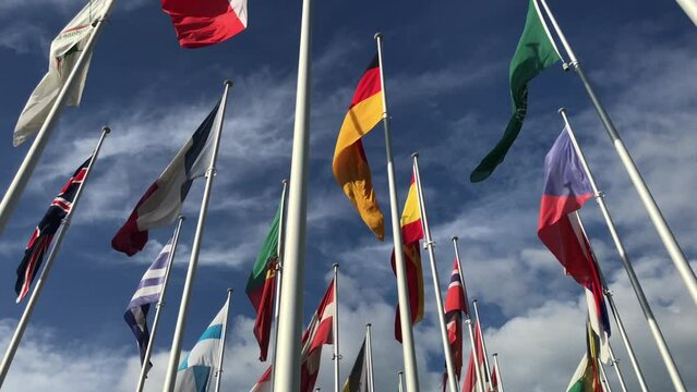 Flags of many countries vawing in the wind with blue sky and white clouds. for political, international trade, relationship concepts, international crisis, NATO organization, s