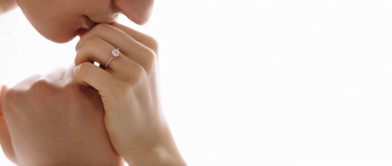 She told him yes. Close-up of a young man kissing his wife's hand with gold ring while making a...