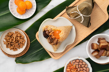 Zongzi. Rice dumpling for Dragon Boat Festival on bright marble table background with ingredient.