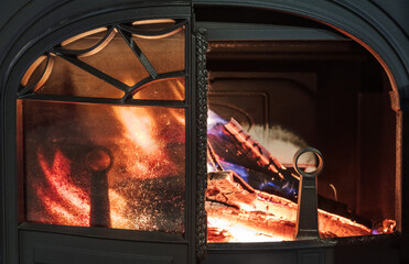 burning wood in the stove in country house - 504907112