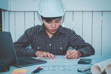 Concept architects Asian woman engineer holding pen pointing equipment architects On the desk with...