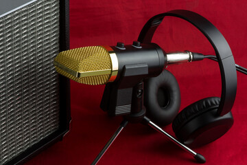 Microphone with Amplifier and Headphones on a Red Cloth Background