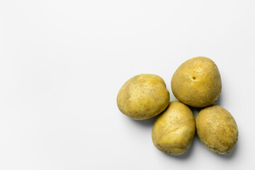 Top view of ripe potatoes on white background.