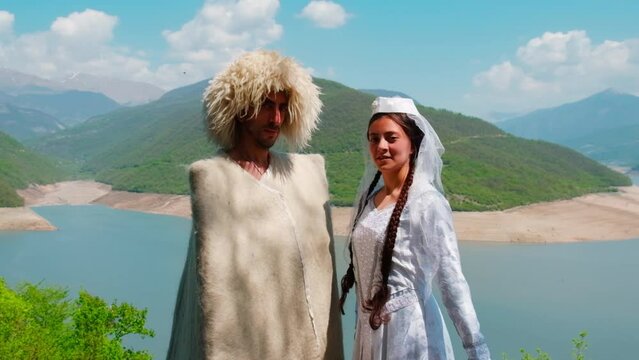 A girl and a man in a papakha and national Georgian costume. Selective focus.