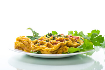 Egg omelet stuffed with greens and sausage fried in the form of waffles