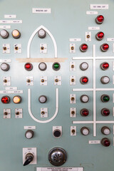 Shipboard emergency switchboard supplying electrical equipment. Bulbs, buttons and switches on the electrical distribution board.