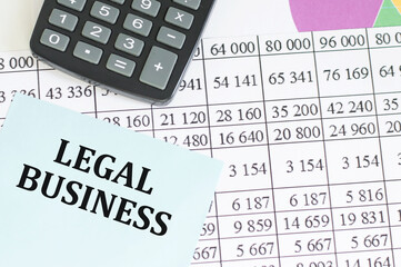 Text LEGAL business inscription on a blue card on the background of reports and diagrams, business...