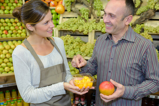 tasting the free sample of fruit