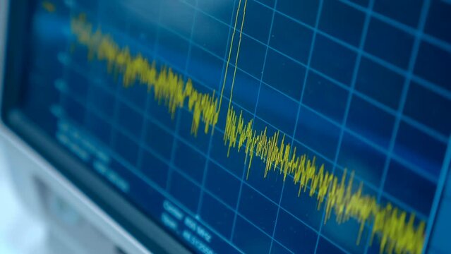Sinusoid or harmonic oscillations with random amplitude on a graph on the screen of a device for scientific, industrial use for accurate measurement of various processes in chemistry, physics. Closeup