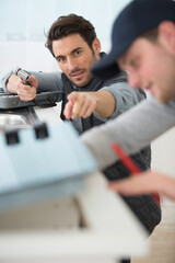 two workers checking appliance together
