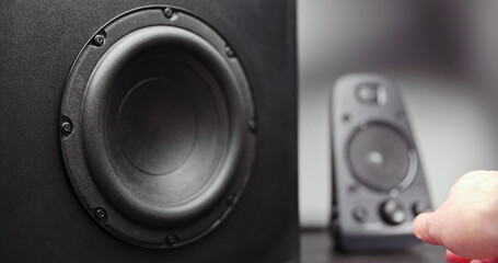 Turning on speakers with subwoofer moving closeup
