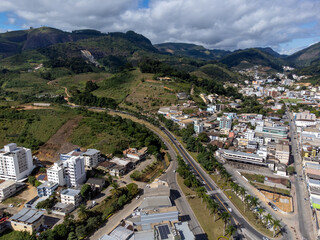 Fototapeta na wymiar Beautiful highway in a small and organized country town with lots of vegetation, aerial drone view, Venda Nova do Imigrante, Espirito Santo, Brazil