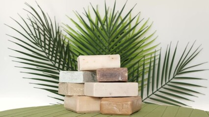 Natural beauty soaps rotating on green leaves background