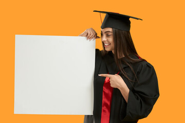 Front view of brunette girl wearing mortarboard and graduate gown, smiling. Pretty young charming...