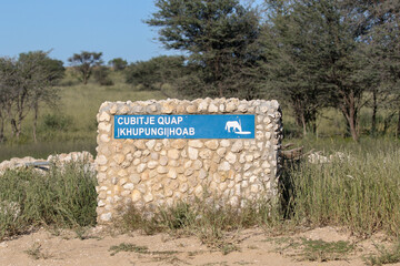 Cubitje Quap (meaning 'stoney flats of the anteaters') waterhole road marker, Kgalagadi,...