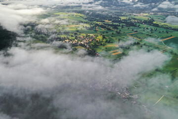 Sunrise in the countryside fields with fog rolling over the farms and villages.