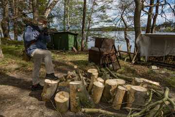 Stockholm, Sweden A man carries wood to a woodpile for later splitting as part of a community project.
