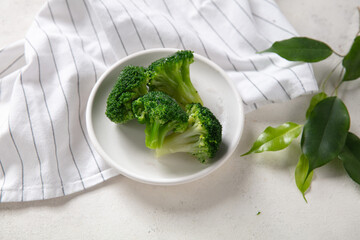 Broccoli, fresh, frozen in a bowl on white background