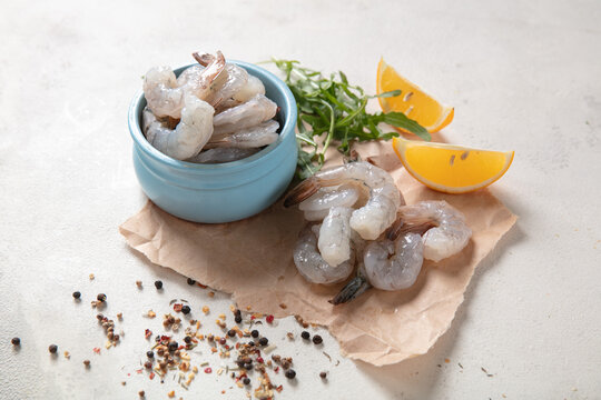 Fresh shrimp tails isolated. Raw headless prawn, pacific shrimp, uncooked prawns, seafood on white background.