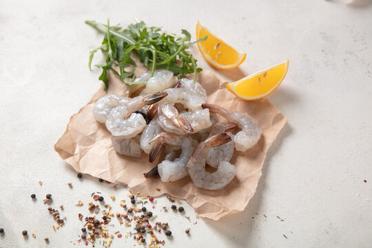 Fresh shrimp tails isolated. Raw headless prawn, pacific shrimp, uncooked tiger prawns, jumbo seafood on white background