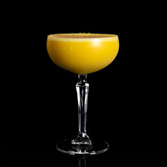 Pumpkin pie martini Halloween cocktail made with mint, Irish cream liqueur, pumpkin puree, vanilla vodka with a granulated sugar rim, a glass of yellow cocktail summer drinks on table black background