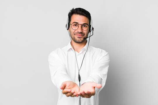 young adult hispanic man smiling happily with friendly and  offering and showing a concept. telemarketer concept