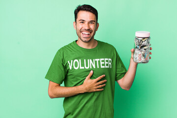 young adult hispanic man laughing out loud at some hilarious joke. donation concept