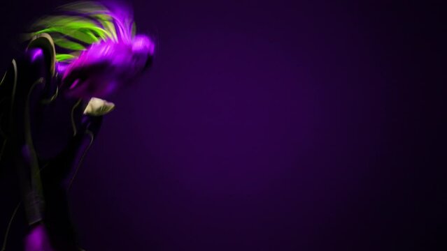 Slim Caucasian flexible young woman bending raising leg dancing robo dance in purple neon light. Portrait of confident artistic dancer in ultraviolet costume performing posing looking at camera