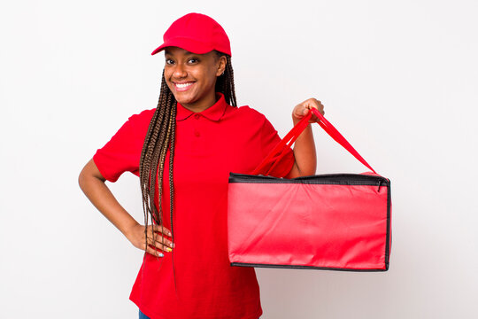 Young Adult Black Woman Smiling Happily With A Hand On Hip And Confident. Pizza Delivery Concept