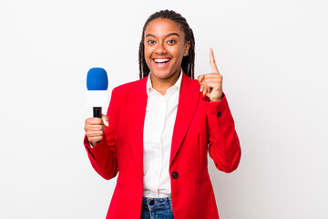 young adult black woman feeling like a happy and excited genius after realizing an idea. presenter...
