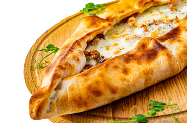 pide with meat and cheese on wooden plate isolated on white background