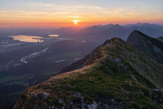 Top of mountain Gro&szlig;e Schlicke at sunrise with valley view of Schwangau and F&uuml;ssen. Tannheimer Valley, Tyrol, Austria