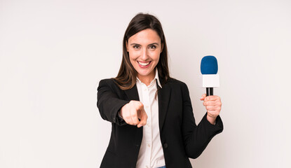 young adult pretty woman pointing at camera choosing you. presenter with a microphone concept