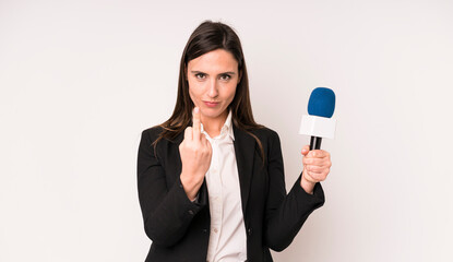 young adult pretty woman feeling angry, annoyed, rebellious and aggressive. presenter with a...