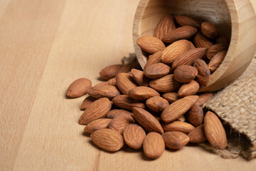 Almonds pour from wood Cup