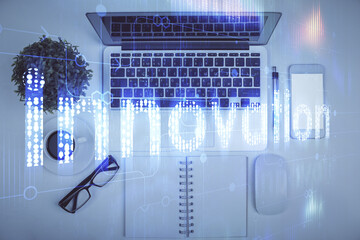 Double exposure of data drawing hologram over topview of study desk background with computer. Concept of Ai.