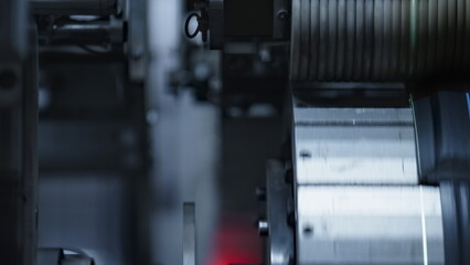 Fototapeta premium Detailed rubber tyre tape on mechanical automated machine rotating in plant