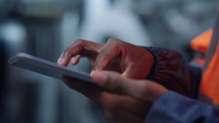 Engineer hands use tablet computer at modern manufacturing factory close up