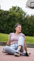 girl sitting on basketball court