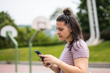 alternative girl smiling with her cell phone
