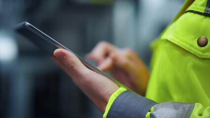 Closeup hands taping tablet computer on manufacturing modern facility factory.