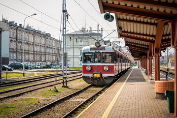 Naklejka na ściany i meble Suburban train at the railway station