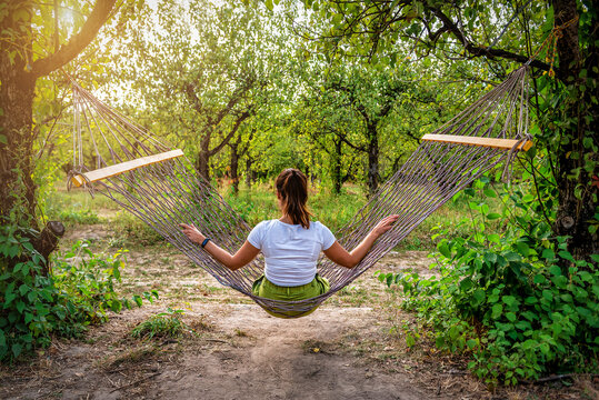 Woman On A Wicker Hammock In The Garden