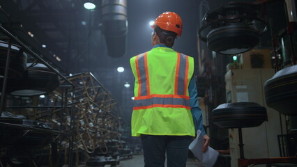 Woman supervisor checking work at huge modern technologies digital warehouse.