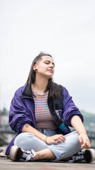 smiling girl sitting in front of the river