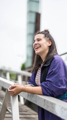 smiling girl sitting in front of the river