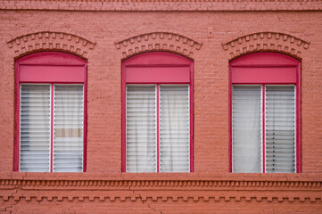Red Brown Brick Building with Red Window Frames.